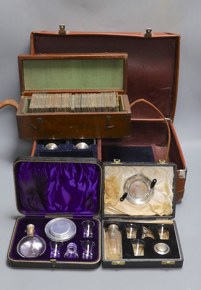 Three cased communion sets together with a mahogany box of slides